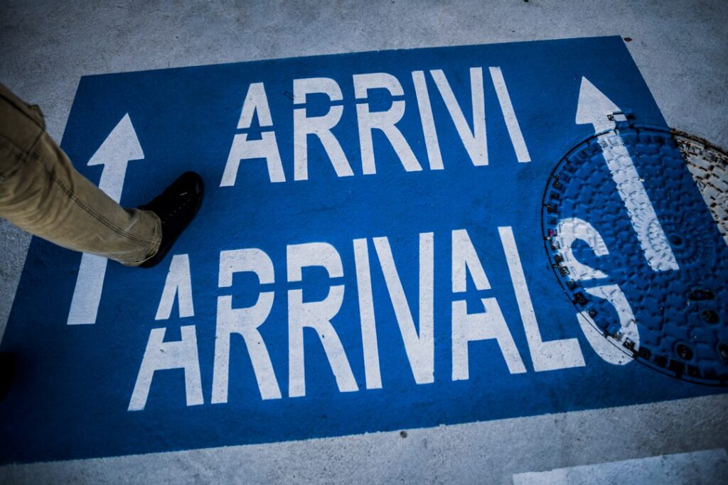 Airport arrivals signage on the floor — meet and greet taxi collection point