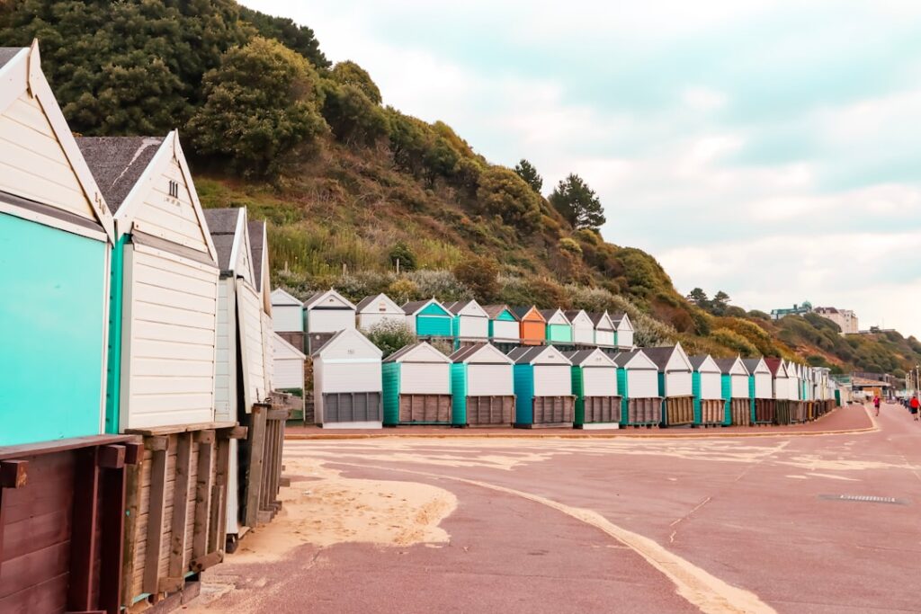 Colourful beach huts lining the sandy promenade at Bournemouth, Dorset