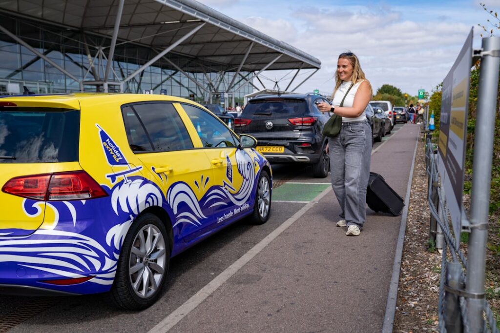 Passenger arriving at a UK airport car park for a pre-booked transfer — airport transfers Dorset
